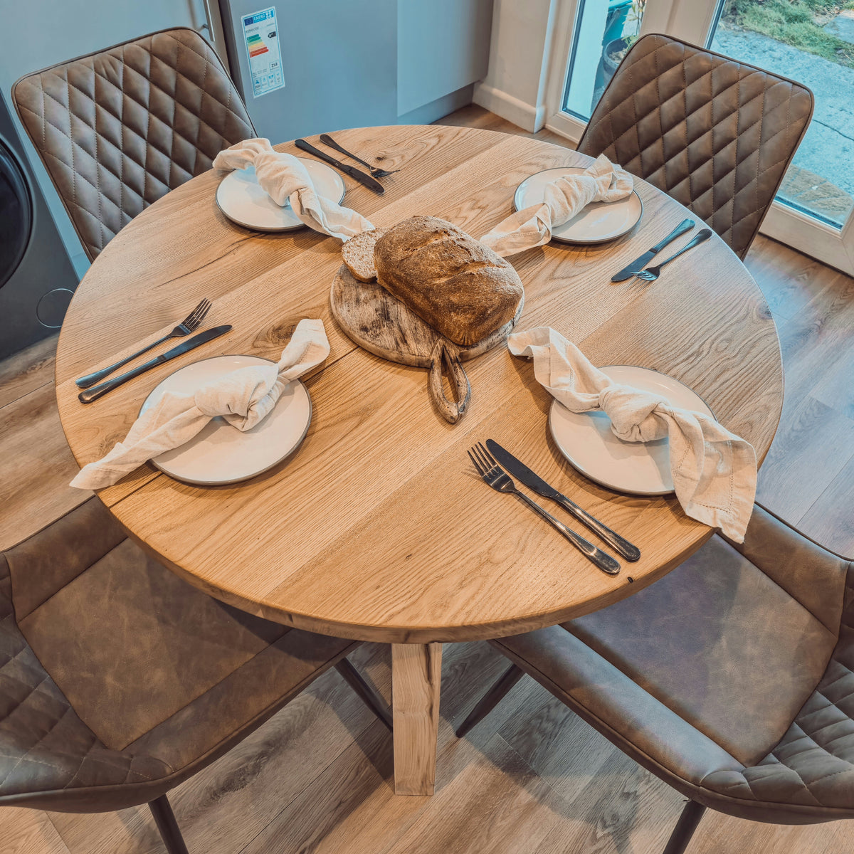 Solid Oak Round Dining Table With Wooden Legs and Leather Chairs