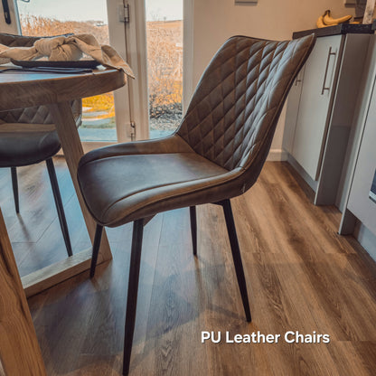 Solid Oak Round Dining Table With Wooden Legs and Leather Chairs