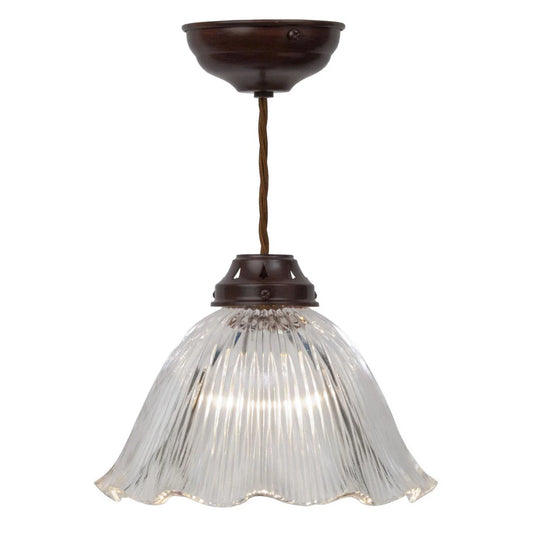 Medium clear antique bronze frill pendant light by Kansa hanging from a wood base, showcasing elegant design and craftsmanship.