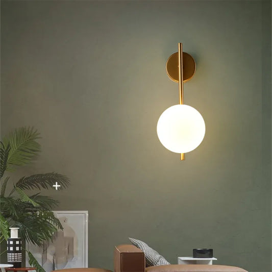 Gold Globe Wall Lamp from Light My House, luxury bedroom and living room light fixture with a spherical gold design.