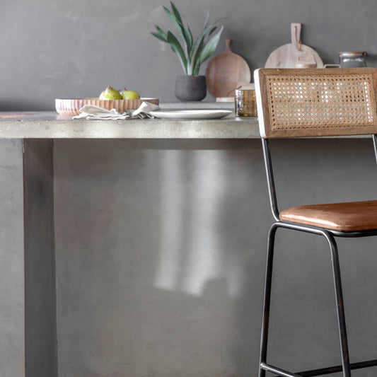 Iswa leather and cane counter chair in aged tan, featuring a wooden frame and woven cane seat, by Lush & More.