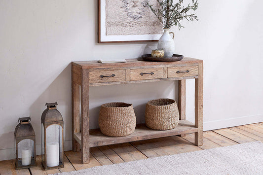 Nkuku Ibo reclaimed wood console table with three drawers in natural finish, showcasing a rustic, handcrafted design.