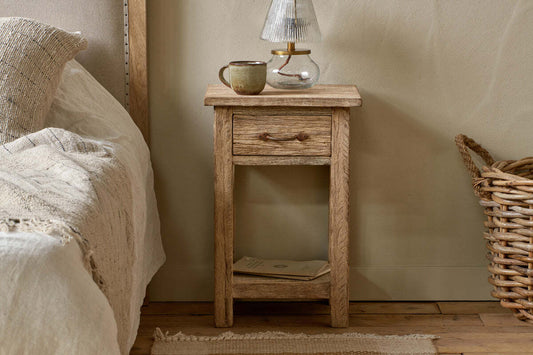 Natural reclaimed wood bedside table by Nkuku, featuring a simple, rustic design with clean lines and a compact size.