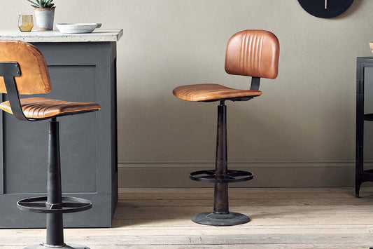 Nkuku Narwana bar chair in aged tan leather with metal legs, stylish and comfortable for bar or counter seating.