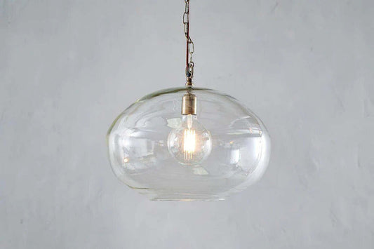 Large clear Otoro recycled glass pendant light by Nkuku, featuring a round shape and modern design for stylish interior lighting.