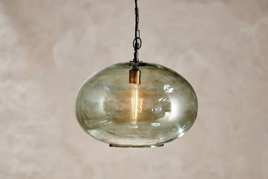 Large green Otoro recycled glass pendant light with a round shape, designed by Nkuku for modern interior decor.